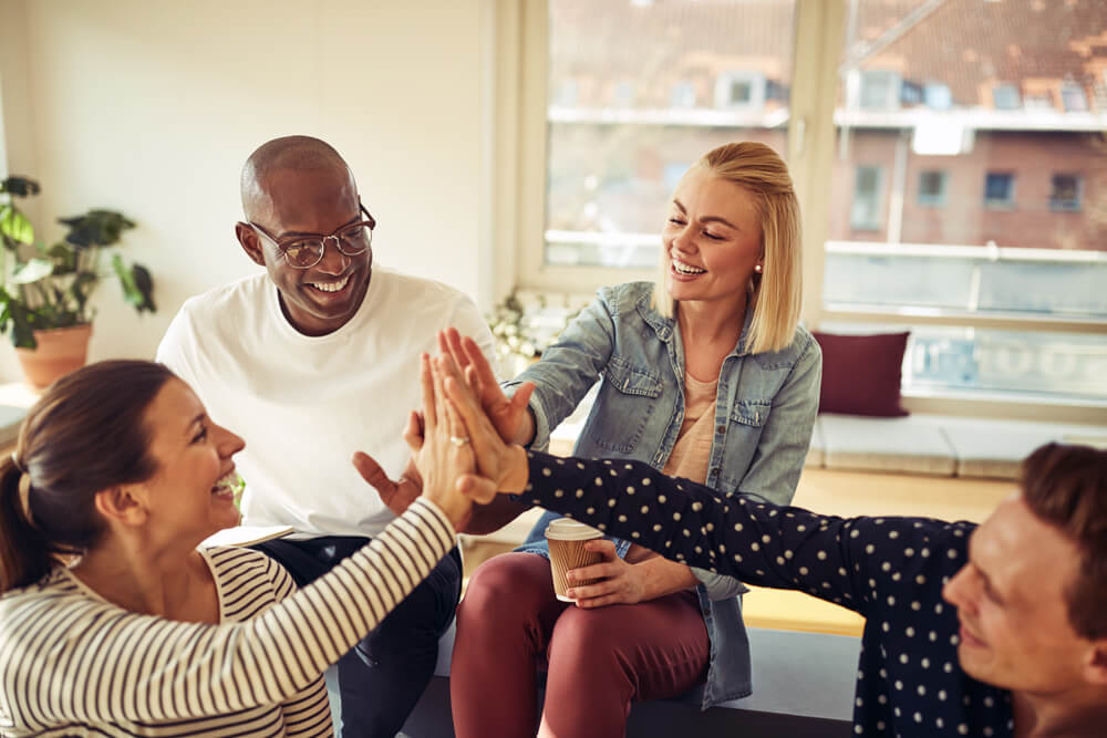 four friends doing high five