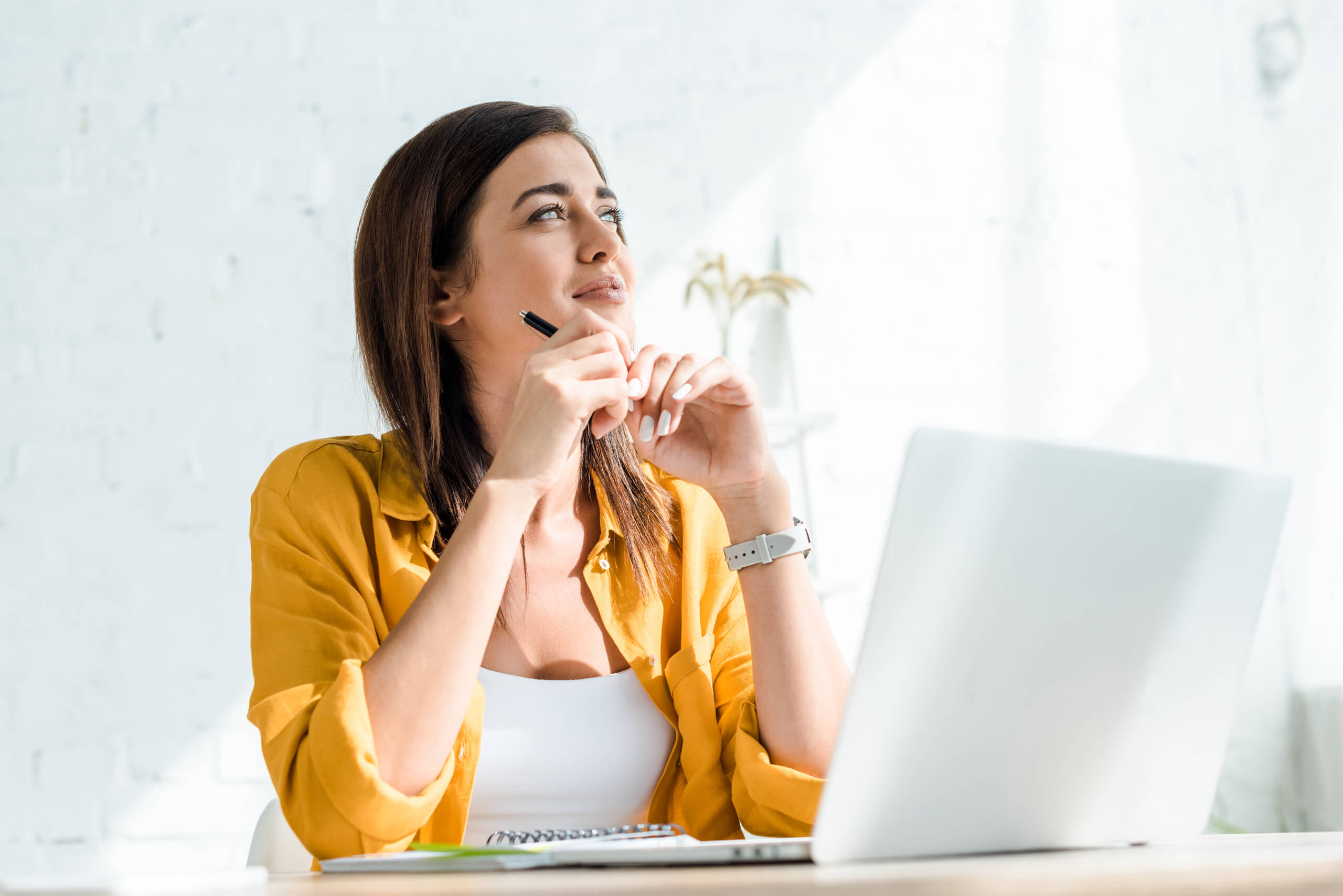 woman with laptop thinking