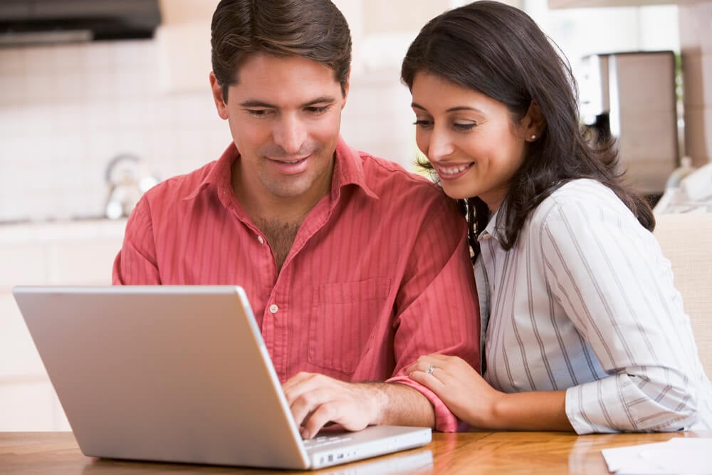 Husband and wife using laptop