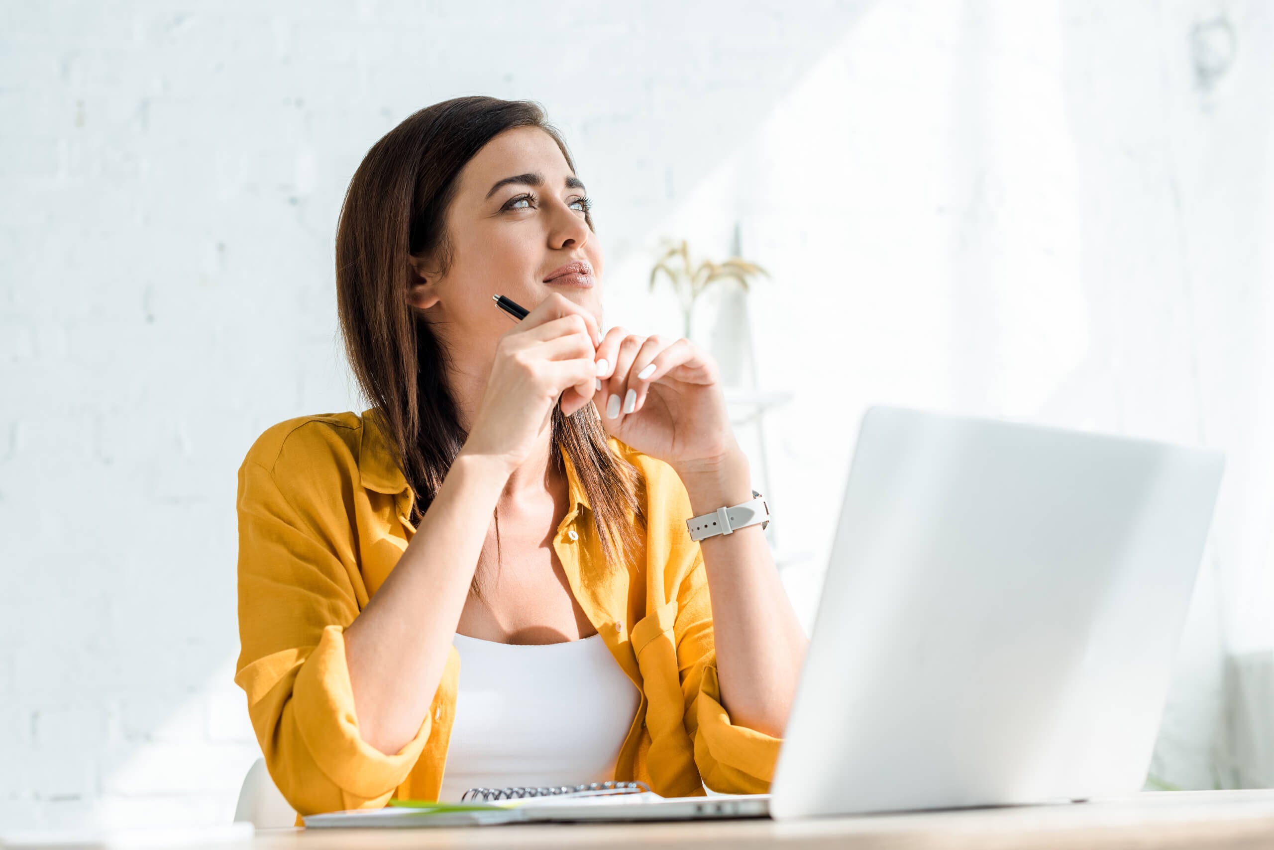 woman with laptop thinking
